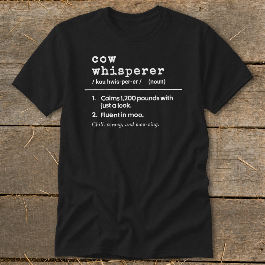 Black t-shirt with "Cow Whisperer" definition and humorous descriptions.