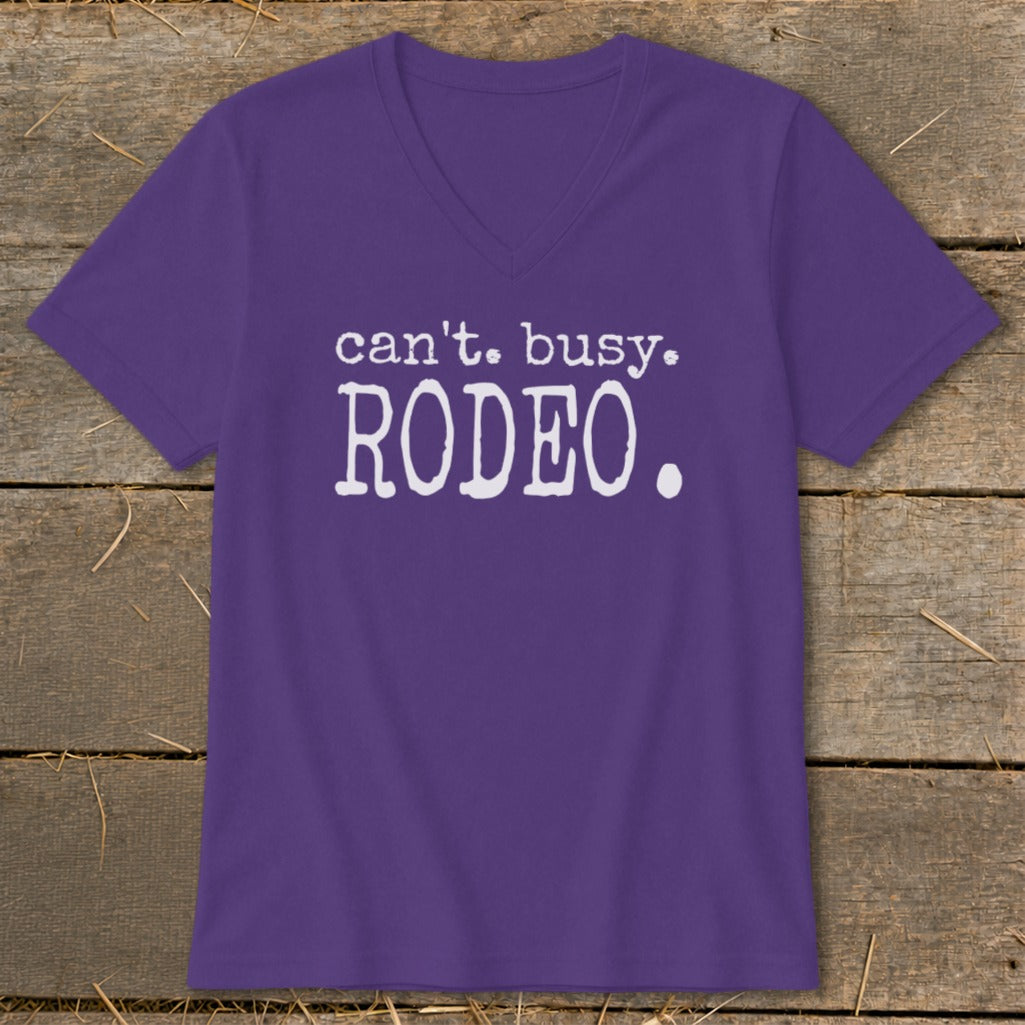 Purple v-neck t-shirt with white text that reads "can't. busy. RODEO."