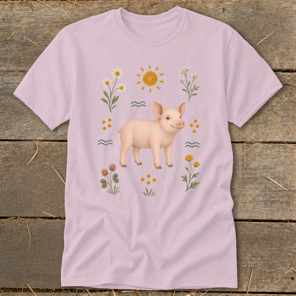 Pink t-shirt with a smiling pig surrounded by flowers and a sun.