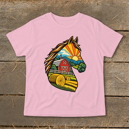 Pink t-shirt featuring a graphic of a horse head silhouette filled with a rural landscape.