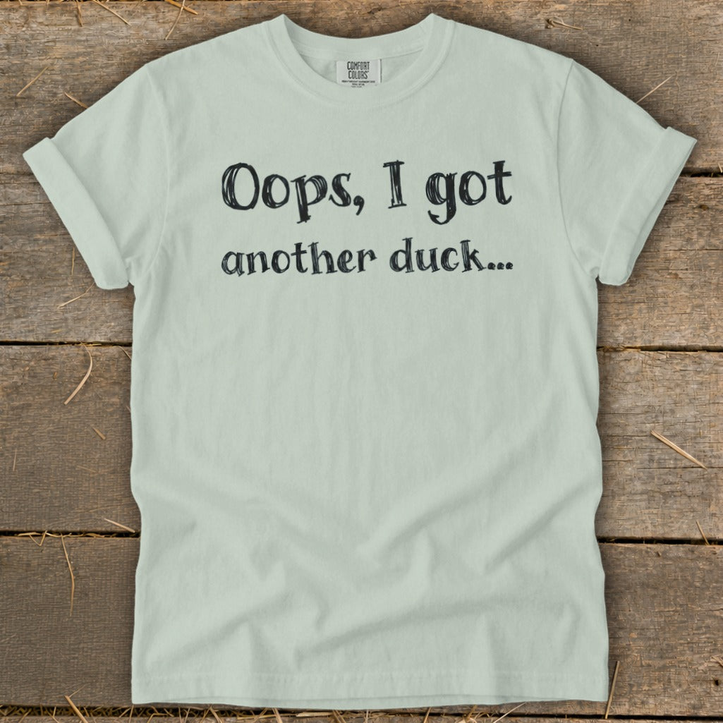 Light mint green t-shirt with black text that reads "Oops, I got another duck..."