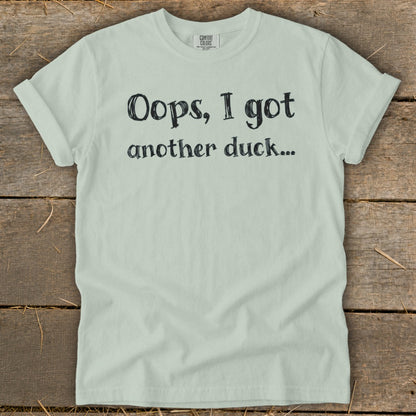 Light mint green t-shirt with black text that reads "Oops, I got another duck..."