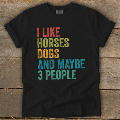 Black t-shirt with text "I like horses dogs and maybe 3 people" in retro font.