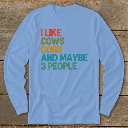 Light blue long-sleeve shirt with text "I LIKE COWS DOGS AND MAYBE 3 PEOPLE."