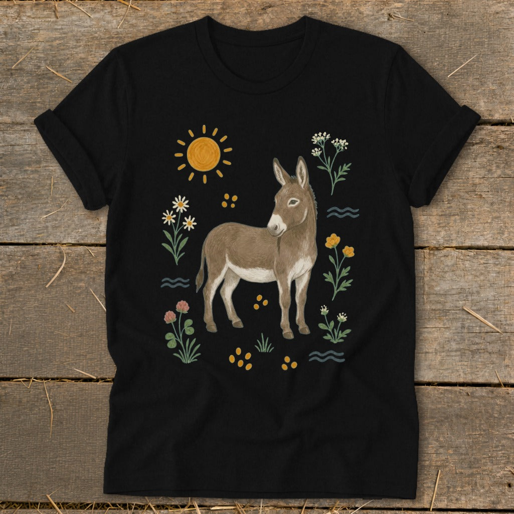 Black t-shirt with a cartoon donkey surrounded by sun, flowers, and waves.