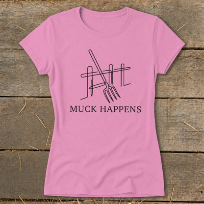 Pink t-shirt with a line drawing of a pitchfork and fence, and the text "MUCK HAPPENS".
