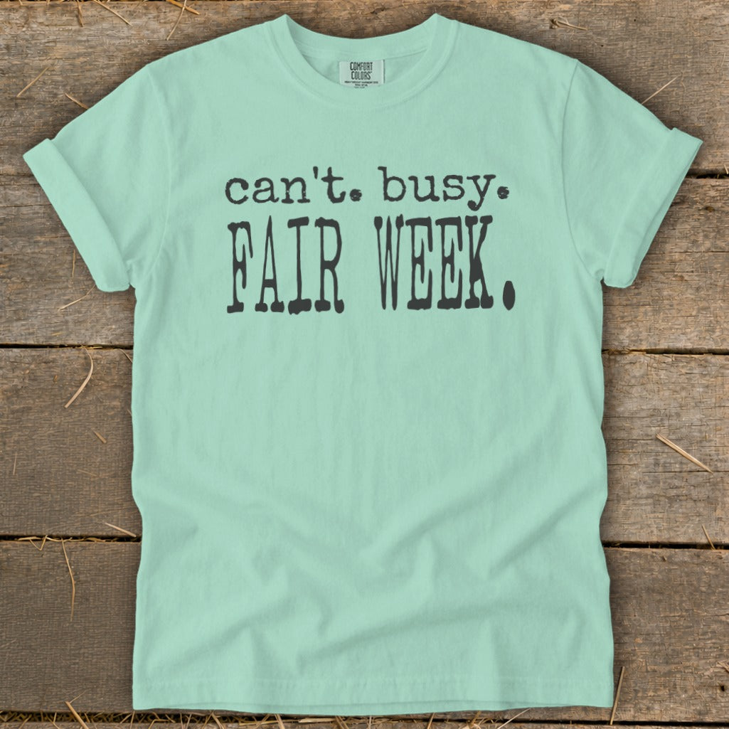 Mint green t-shirt with "can't. busy. FAIR WEEK." text.
