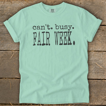 Mint green t-shirt with "can't. busy. FAIR WEEK." text.