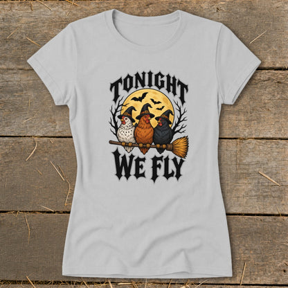 Three chickens wearing witch hats sit on a broomstick with the text "TONIGHT WE FLY".