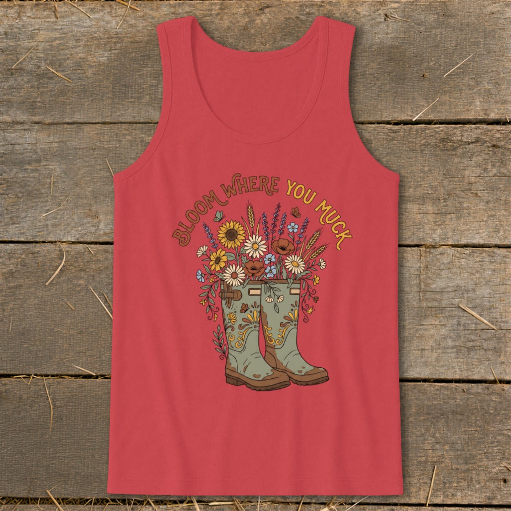 Red tank top with a floral bouquet emerging from gardening boots and text "Bloom Where You Muck."