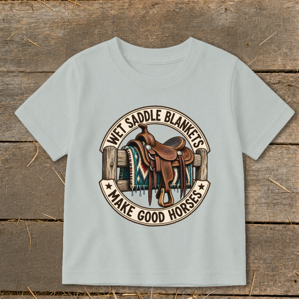 T-shirt with saddle on a fence and text "Wet Saddle Blankets Make Good Horses."