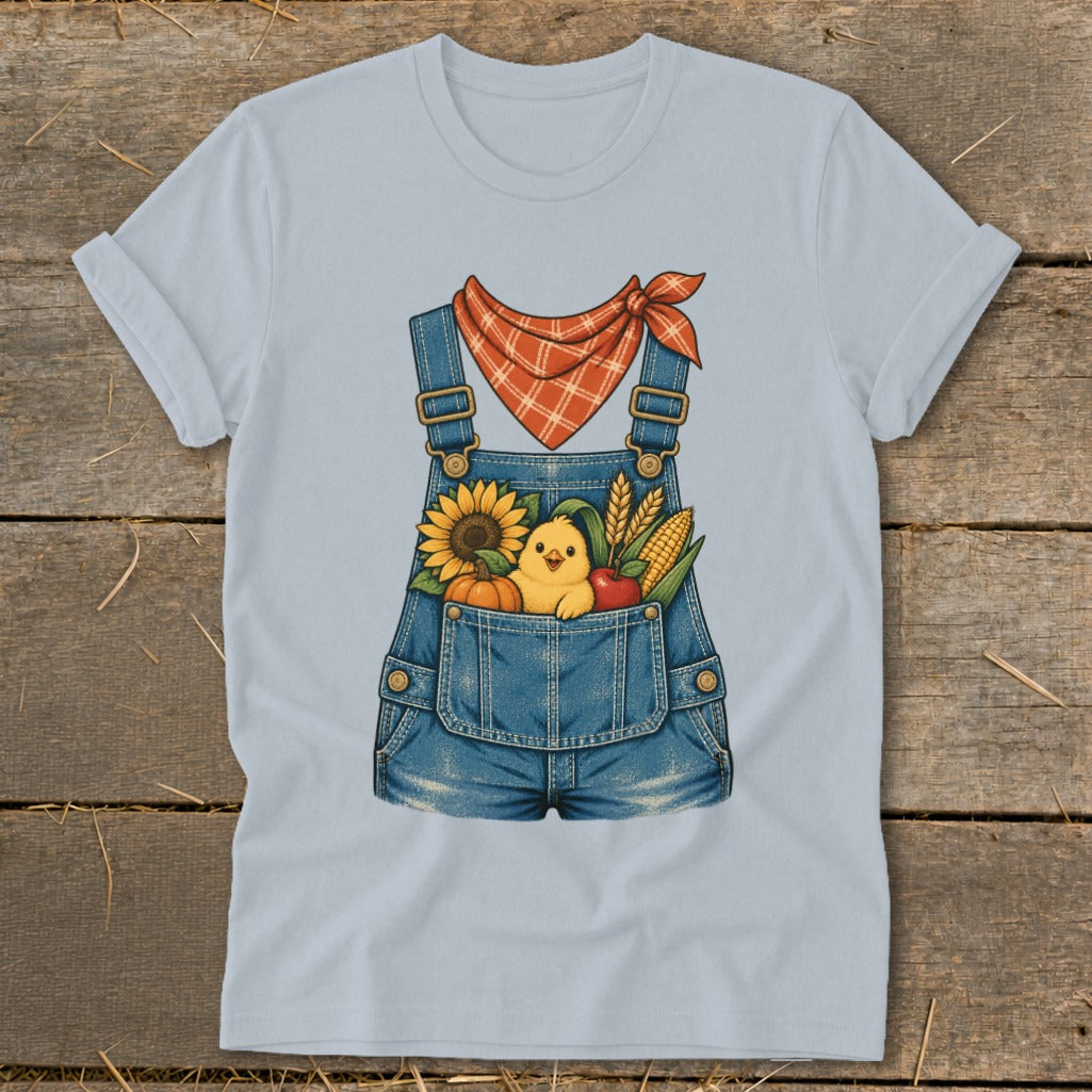 Light blue t-shirt with denim overalls graphic featuring a chick, sunflower, pumpkin, apple, and corn.
