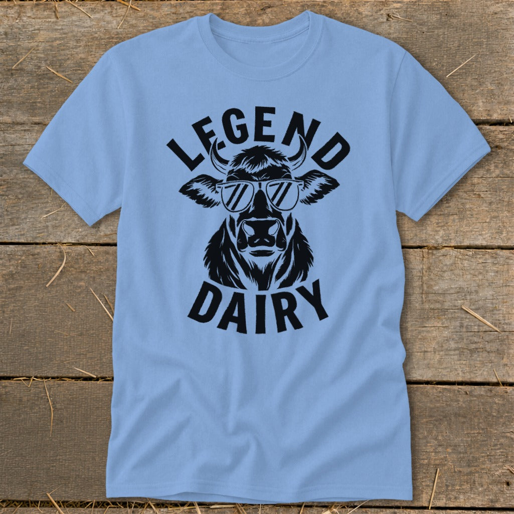 Light blue t-shirt with black graphic of a cow wearing sunglasses and text "LEGEND DAIRY".