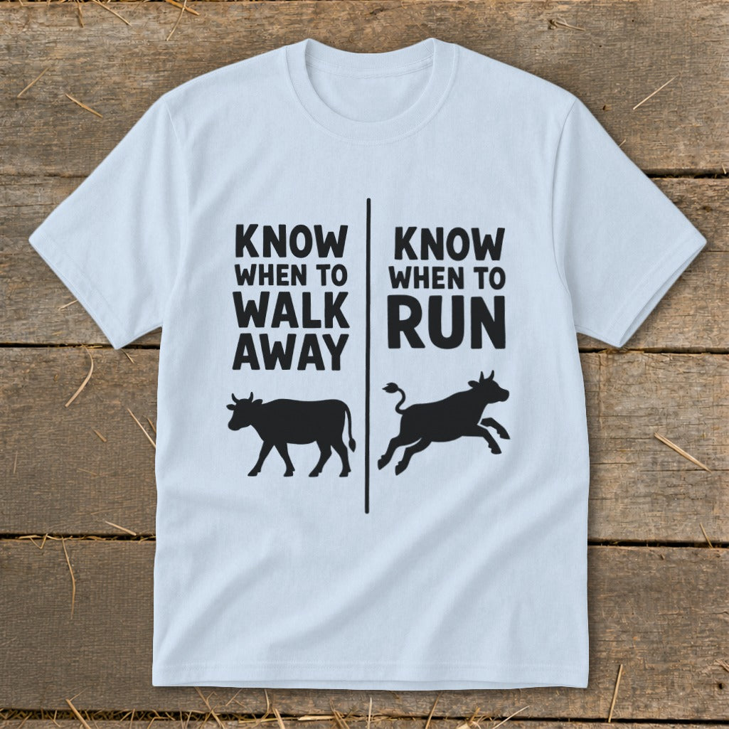 Light blue t-shirt with black text and cow silhouettes reading "Know when to walk away" and "Know when to run".