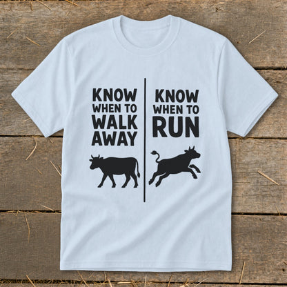 Light blue t-shirt with black text and cow silhouettes reading "Know when to walk away" and "Know when to run".