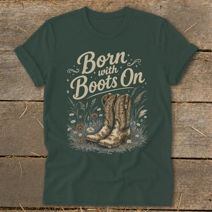T-shirt graphic with "Born with Boots On" text above cowboy boots and flowers.