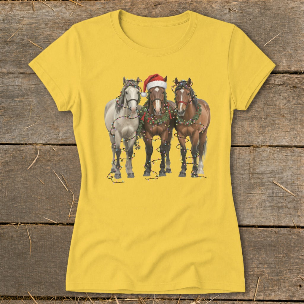 Three horses decorated with Christmas lights and a Santa hat.