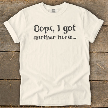 Cream t-shirt with black text reading "Oops, I got another horse..."