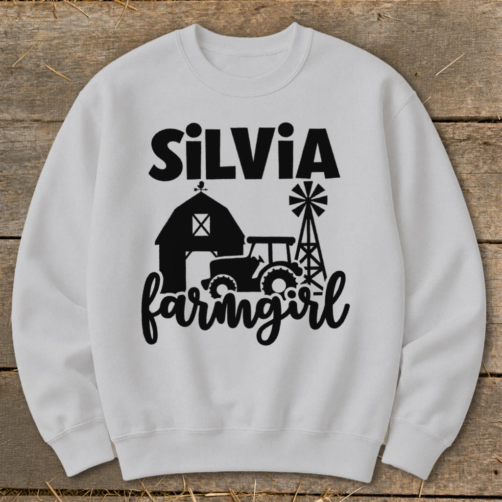 White sweatshirt with "SilVia farmgirl" text and farm graphics.