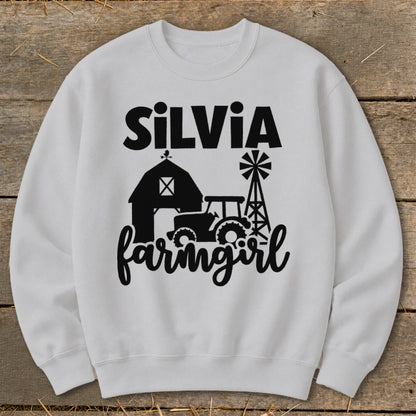 White sweatshirt with "SilVia farmgirl" text and farm graphics.