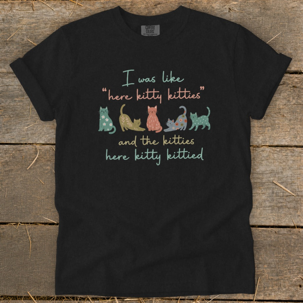 Black t-shirt with text "I was like 'here kitty kitties' and the kitties here kitty kittied" and cartoon cats.