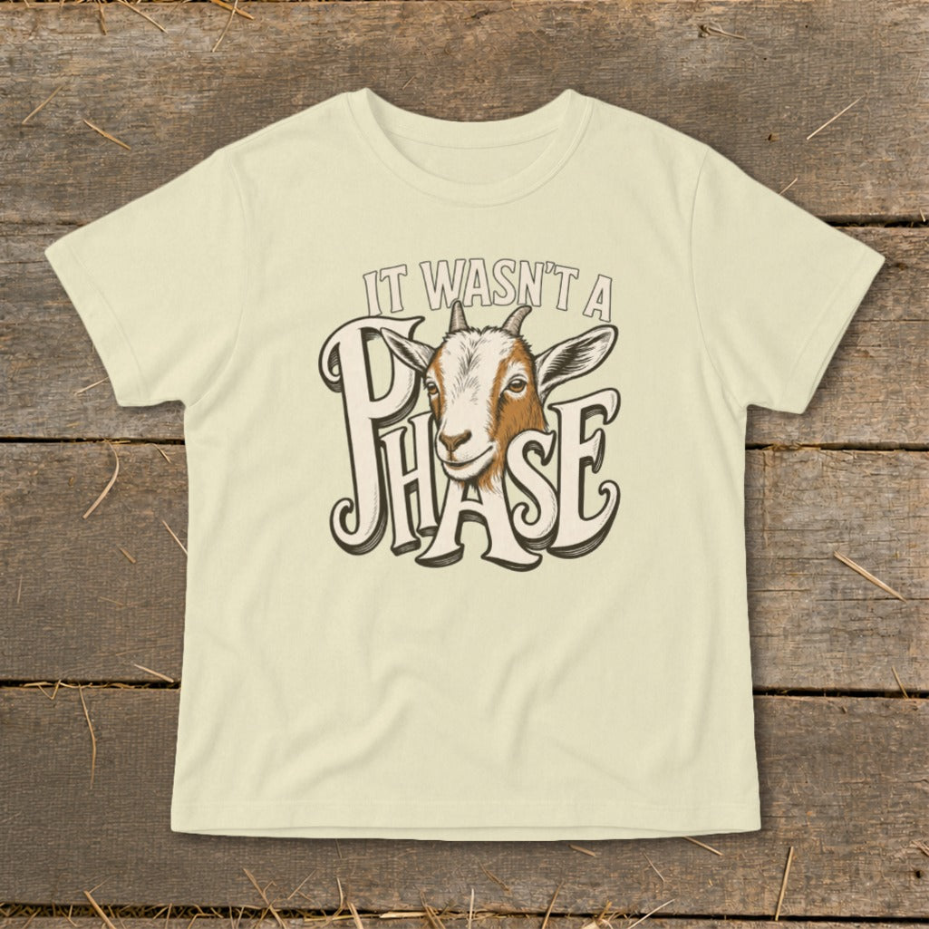 Light yellow t-shirt with a goat head and text "IT WASN'T A PHASE".