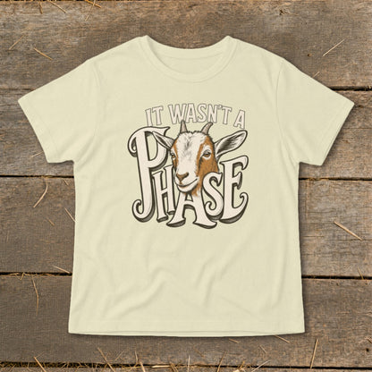 Light yellow t-shirt with a goat head and text "IT WASN'T A PHASE".