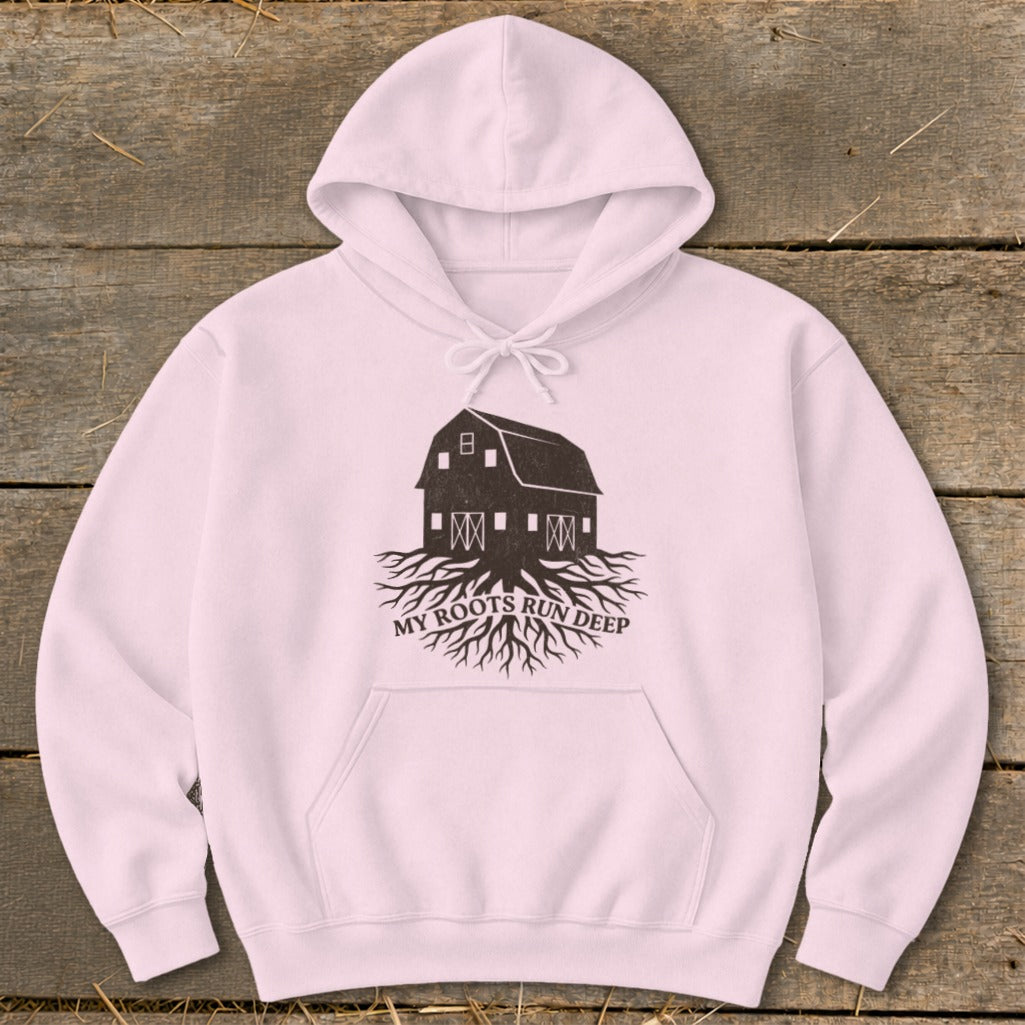 Pink hoodie with a dark barn and roots graphic and the text "MY ROOTS RUN DEEP".