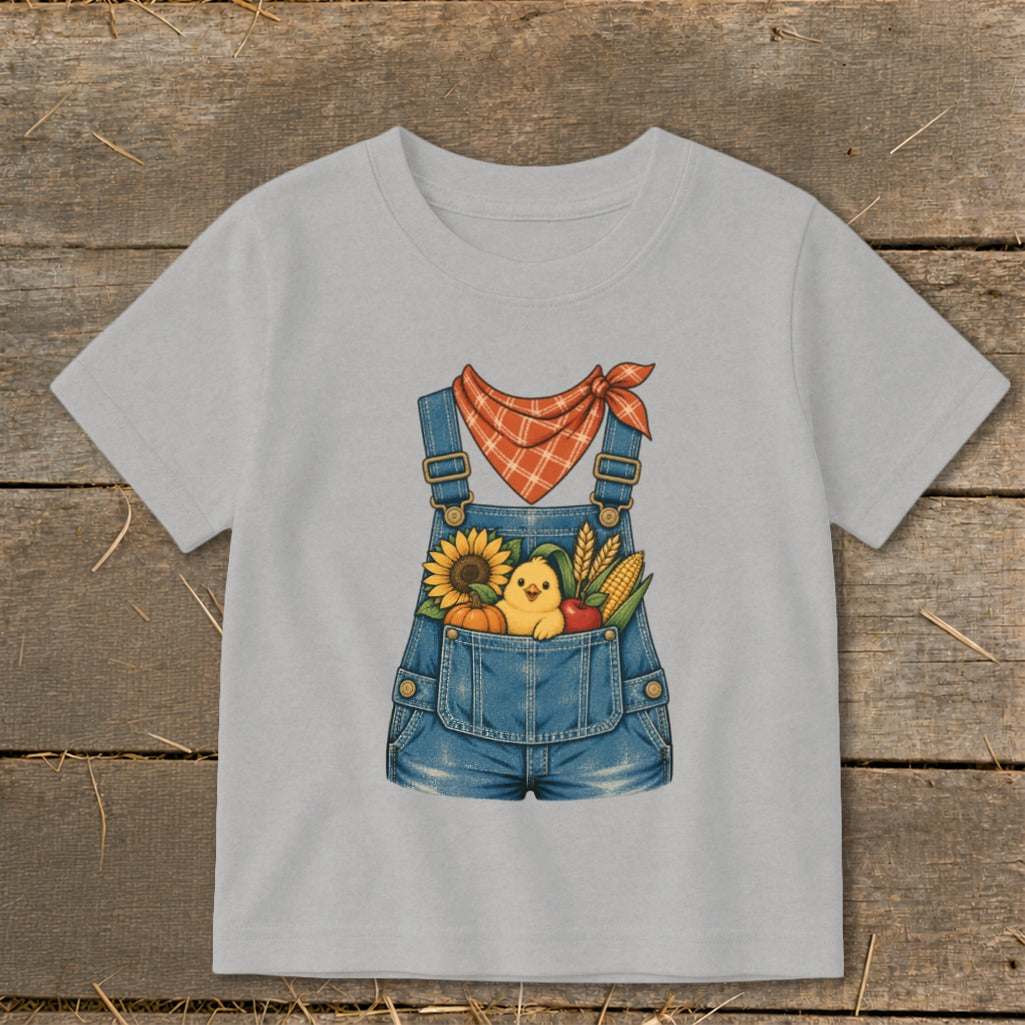 Gray t-shirt with denim overalls graphic holding a chick and autumn harvest items.