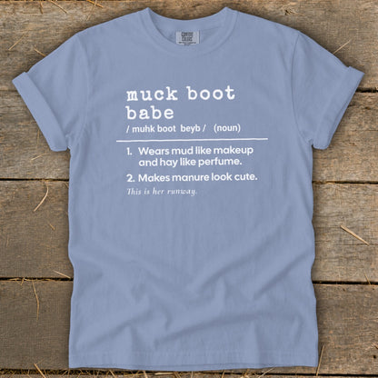 Light blue t-shirt with "muck boot babe" definition printed in white.