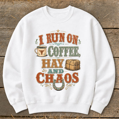 White sweatshirt with "I Run On Coffee, Hay and Chaos" text and graphics.