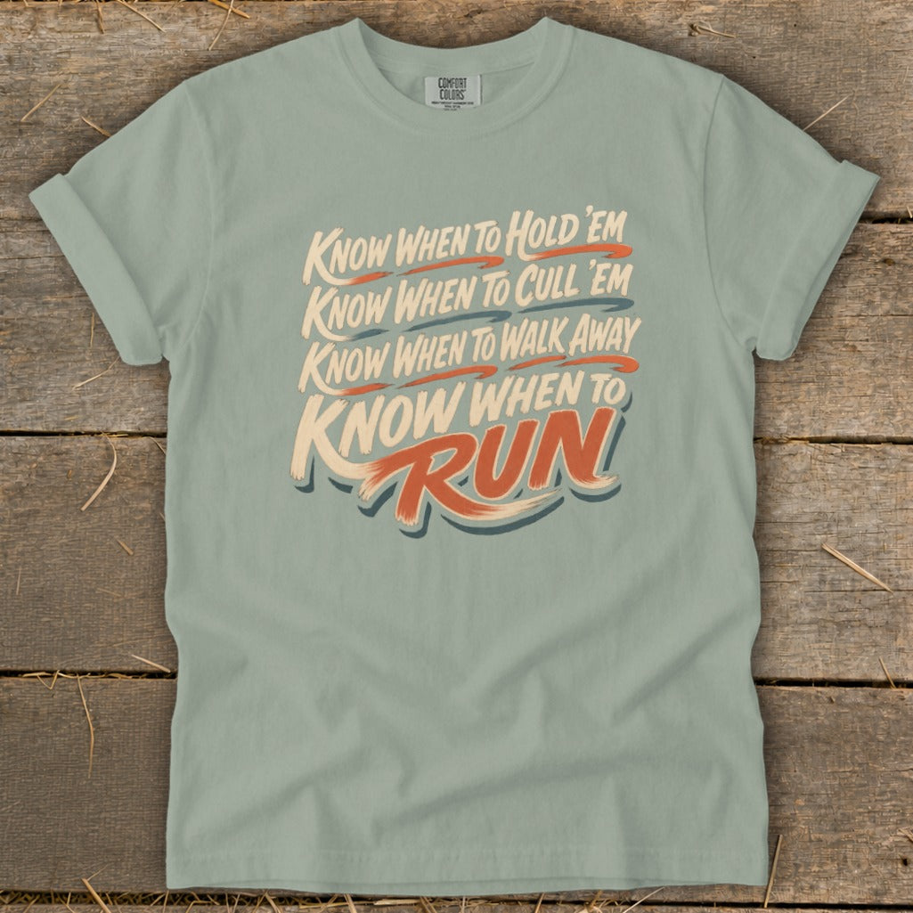 Light blue t-shirt with text: Know When To Hold 'Em, Cull 'Em, Walk Away, Run.