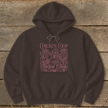 Brown hoodie with pink "Chicken Coop Social Club" text and floral chicken design.