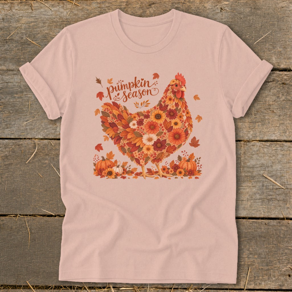 Pink t-shirt with floral chicken and "Pumpkin Season" text, surrounded by pumpkins and leaves.