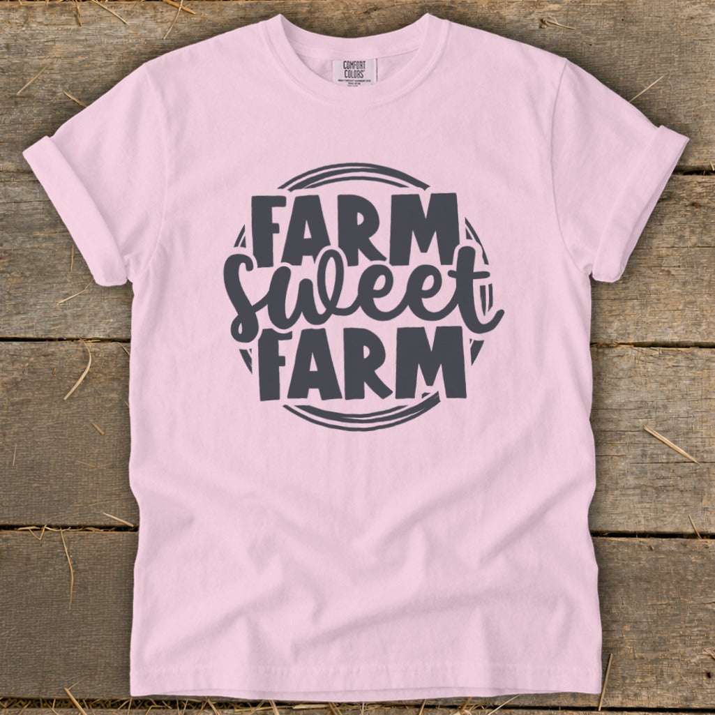 Pink t-shirt with "Farm Sweet Farm" graphic in dark gray text.