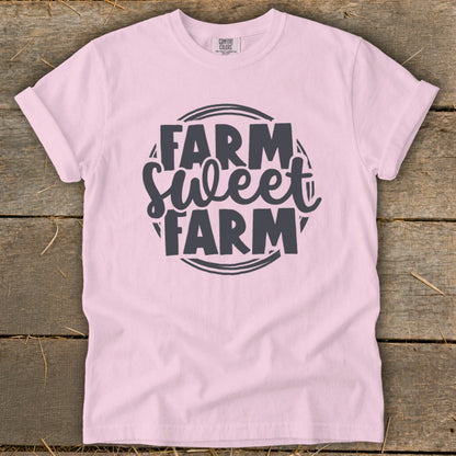 Pink t-shirt with "Farm Sweet Farm" graphic in dark gray text.