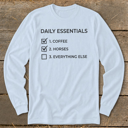 Light blue long-sleeve shirt with "Daily Essentials: 1. Coffee, 2. Horses, 3. Everything Else" text.
