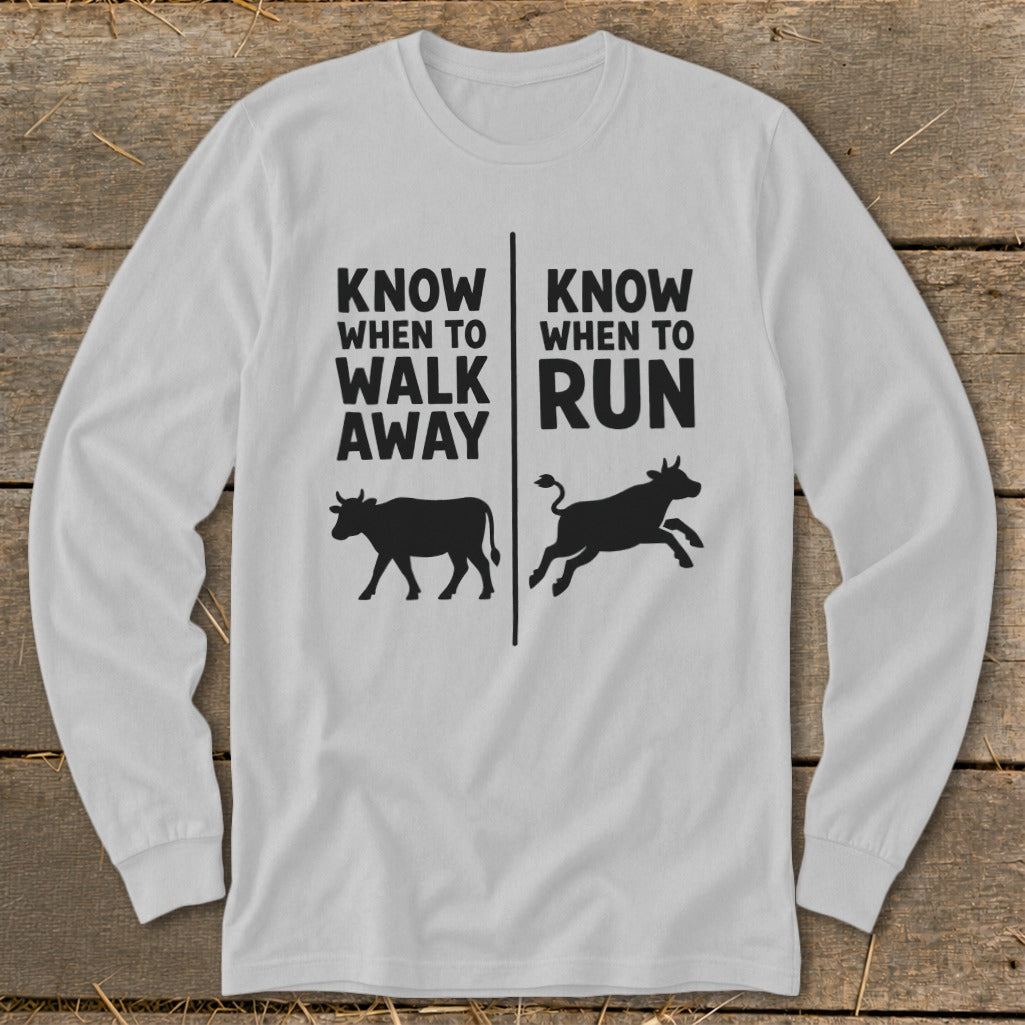 White long-sleeve shirt with "Know When To Walk Away Run" and cow silhouettes.