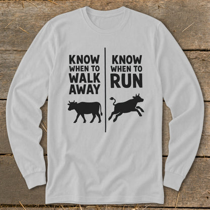 White long-sleeve shirt with "Know When To Walk Away Run" and cow silhouettes.