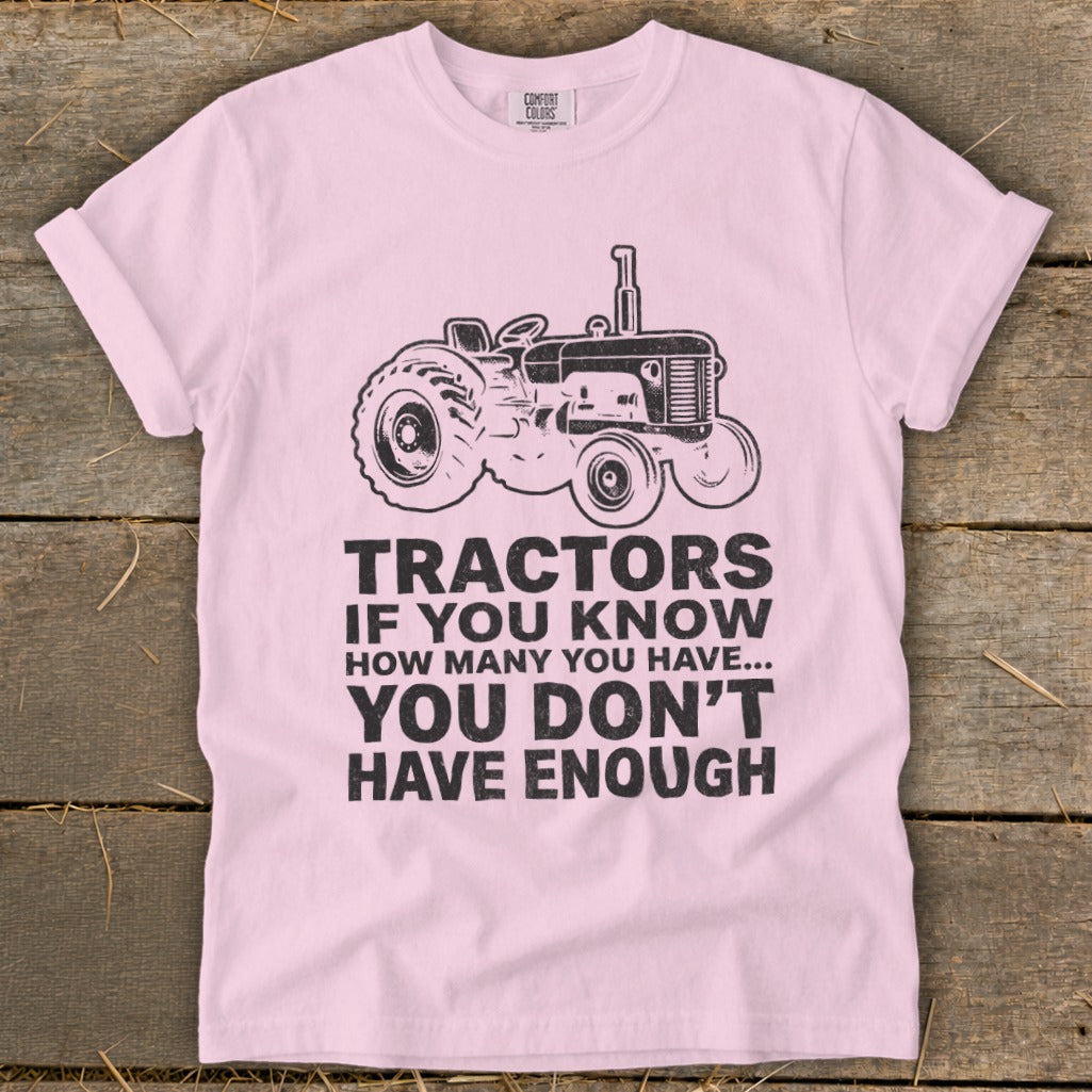 Pink t-shirt with a tractor graphic and the text "Tractors if you know how many you have... you don't have enough."