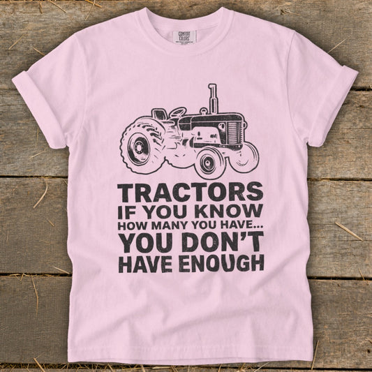 Pink t-shirt with a tractor graphic and the text "Tractors if you know how many you have... you don't have enough."