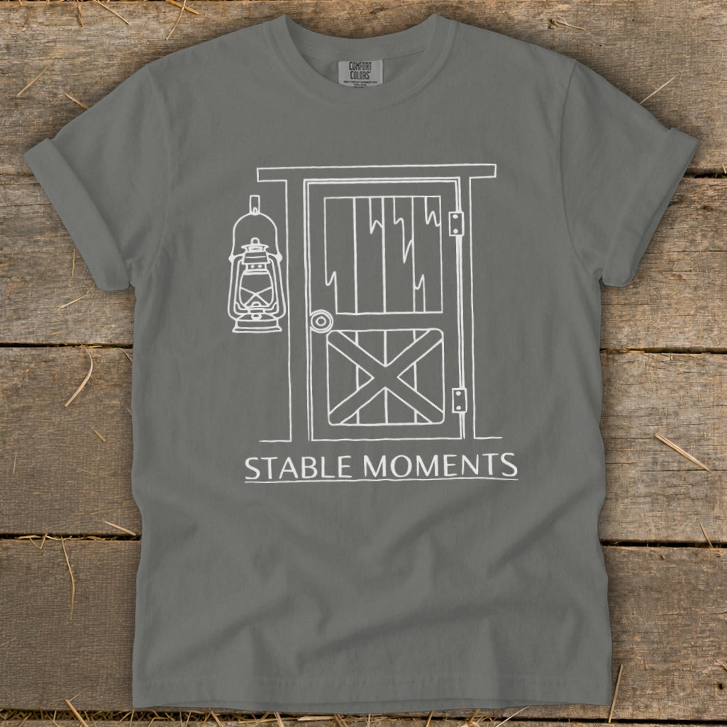 Gray t-shirt with white line art of barn door, lantern, and text "STABLE MOMENTS".