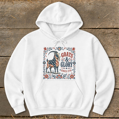 White hoodie with "Goats & Glory Since 1776" text and a goat with American flag design.