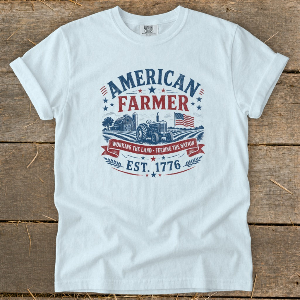 White t-shirt with American Farmer graphic, tractor, barn, and flag.