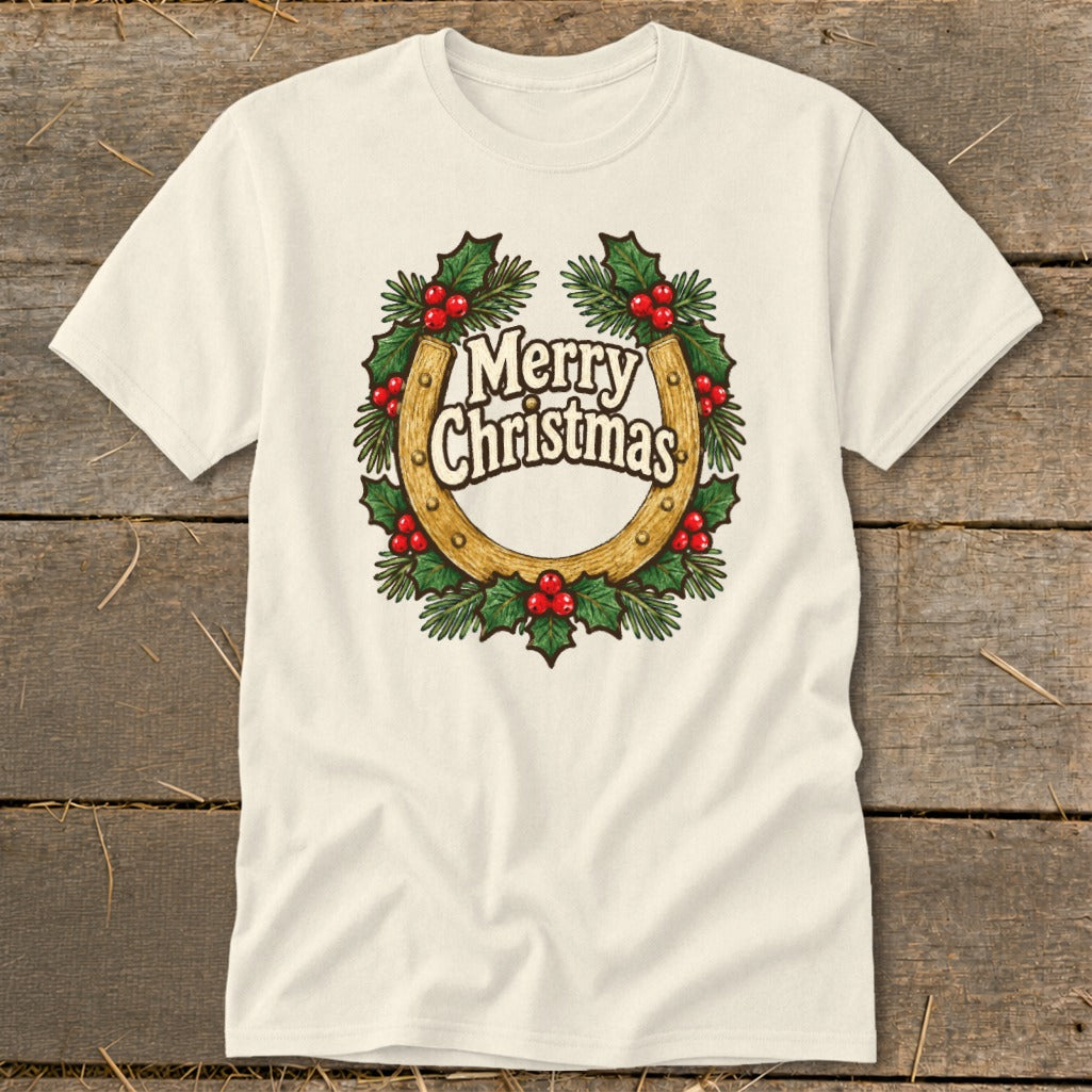 Cream t-shirt with a horseshoe wreath graphic saying "Merry Christmas."