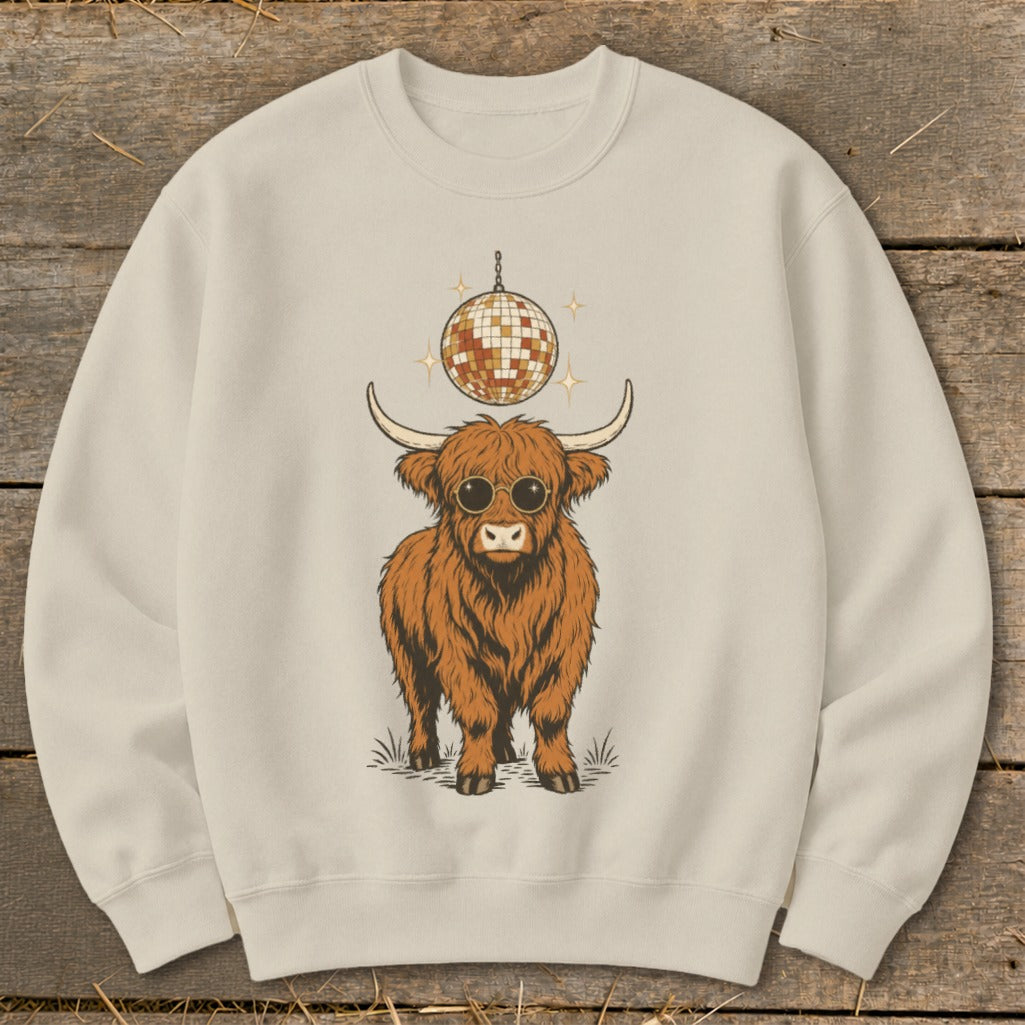 Cream sweatshirt with a graphic of a fluffy Highland cow wearing sunglasses and a disco ball.