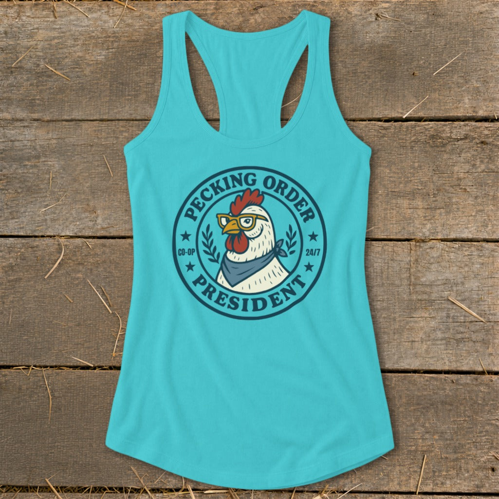 Turquoise tank top with a "Pecking Order President" chicken graphic wearing glasses and a bandana.