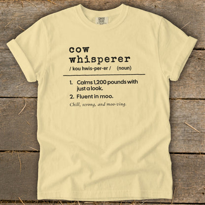 Yellow t-shirt with "cow whisperer" definition: Calms 1,200 pounds, fluent in moo.