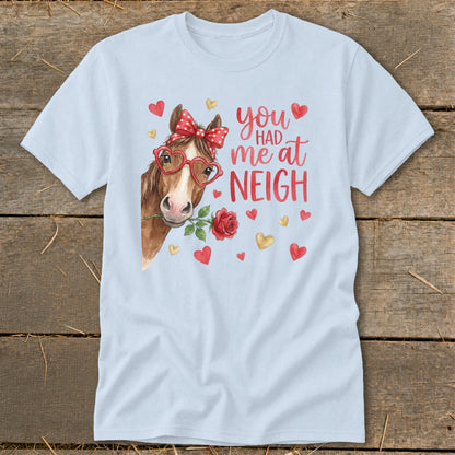 Light blue t-shirt with horse wearing heart glasses, holding a rose, and text "you had me at NEIGH".