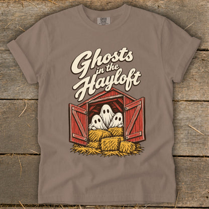 Three ghosts peek out from a red barn with hay bales, with "Ghosts in the Hayloft" text.